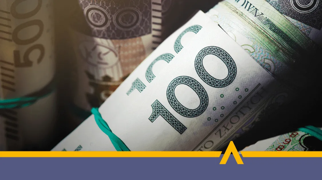Zwinięte w rulony banknoty 100 i 500 złotych, przewiązane gumkami, symbolizujące gotówkę lub finansowanie